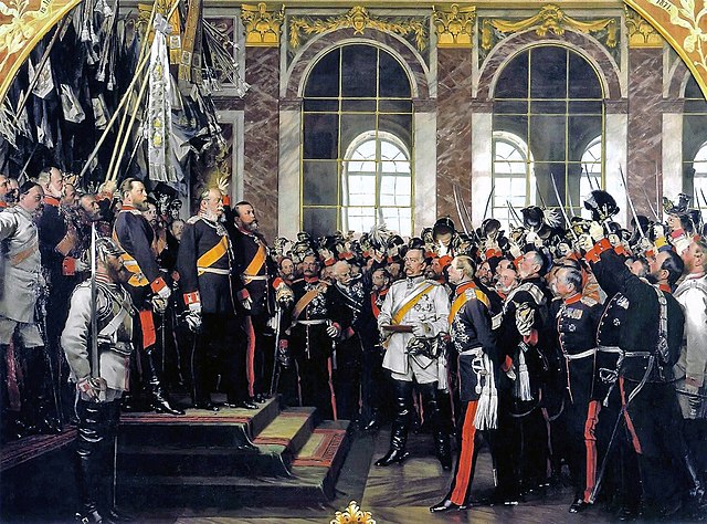 Proclamation of Prussian king Wilhelm I as German Emperor at Versailles in military ceremonial dress standing above crowd that looks up to him. The subjects are portrayed as the age they were when the work was painted in 1885, not the age they were at when the event occurred in 1871.