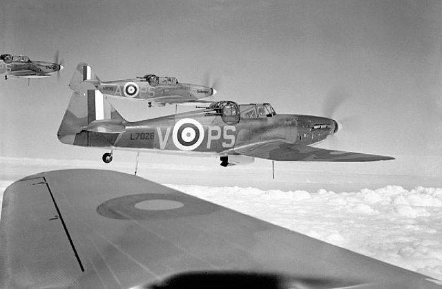 Photograph taken from airplane of three other 264 Squadron Defiants flying above the clouds
