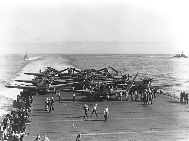 Group of 11 planes known as the Douglas "Devastators" of the U.S. Navy Torpedo Squadron 6 grouped together on USS Enterprise being prepared for takeoff by naval personnel