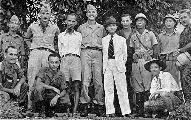 Hồ Chí Minh (third from left, standing in shorts) standing with members of the OSS