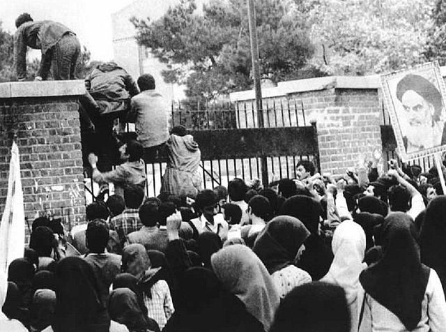 A group of Iranian students climbing over the gates of the US Embassy in Tehran