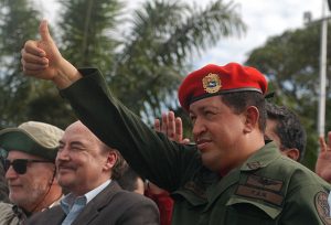 Hugo Chavez in red beret giving a thumbs up