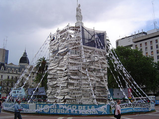 A memorial comprised of images of disappeared victims and banners to protest against the payment of Argentina's external debt