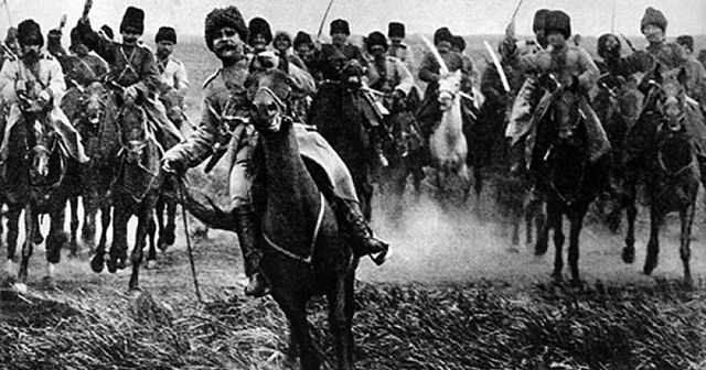 Large group of Russian cavalry in military gear on horses many holding curved swords
