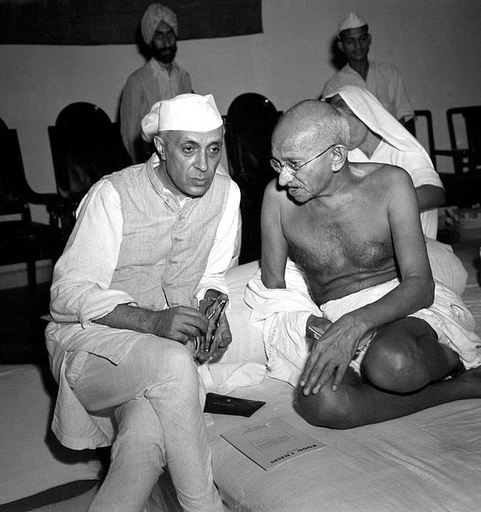 Gandhi sitting and speaking with Jawaharlal Nehru during a meeting of the All India Congress, Bombay, India