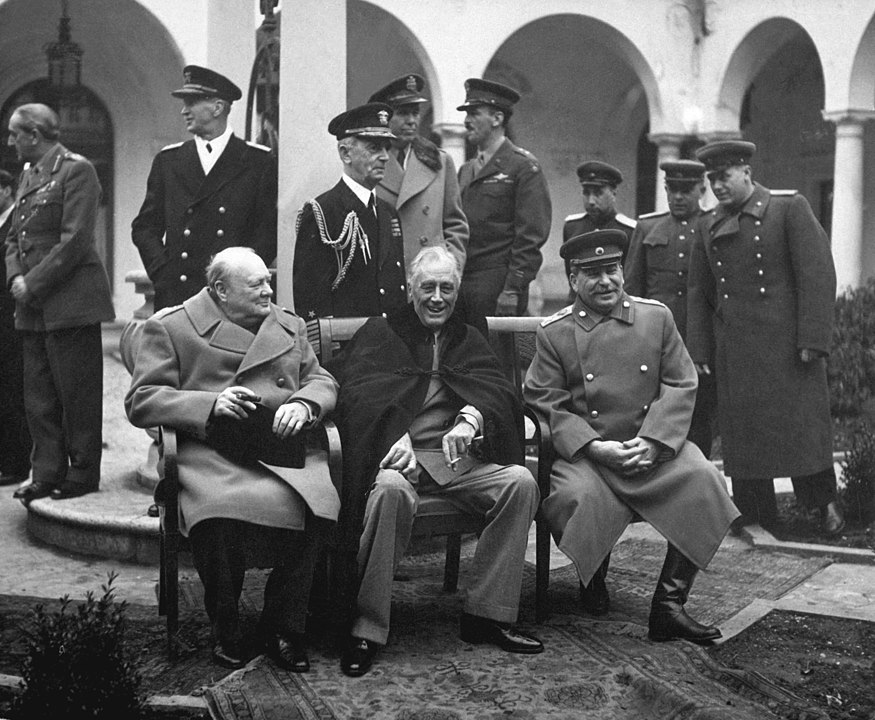 Seated portrait of Churchill (right), FDR (middle, smiling), and Stalin (right, also smiling) at Yalta