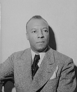 Seated photographic portrait of A. Phillip Randolph in suit and tie
