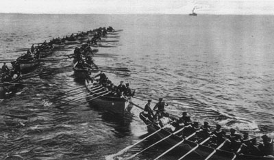 Formation of Japanese galley ships with men rowing large oars during the Battle of Tsingtao