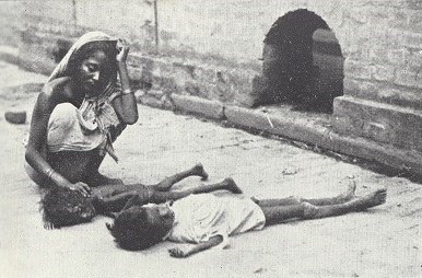 A woman kneels over two dying children lying on the street in Calcutta