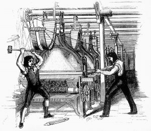 Two men using hammers to break a jacquard loom