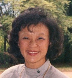 Colored photograph of Myrna Mack Chang smiling at camera