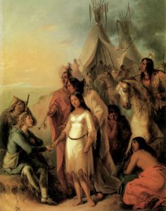 A woman in a white dress with reaching for seated man with numerous people and tents behind her