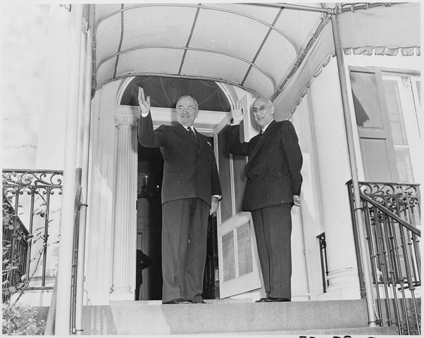 Prime Minister Mosaddegh standing with US President Truman, both men waving