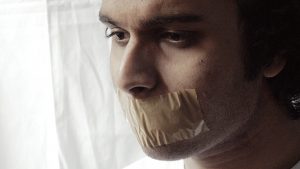 person with tape over their mouth