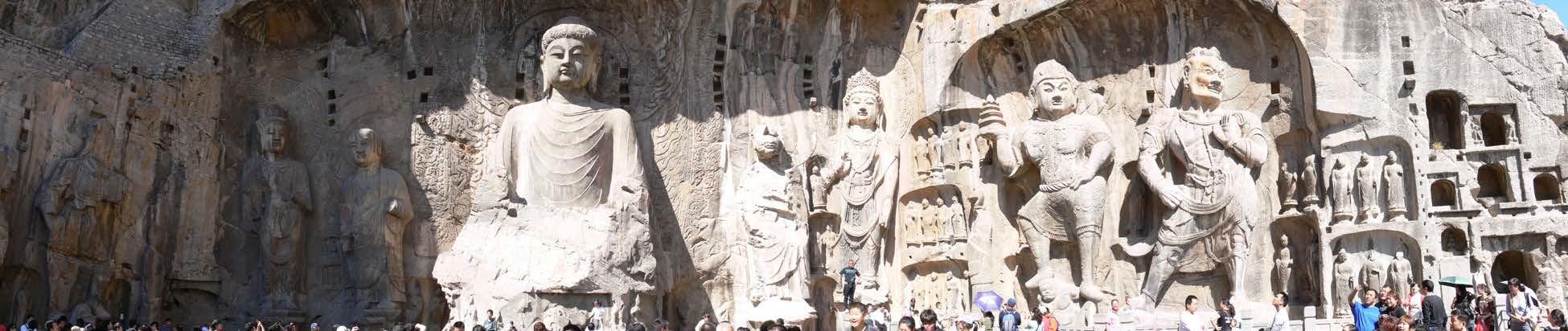 Giant Buddhas carved into stone.