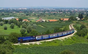 A blue train in a Austrian countrysize