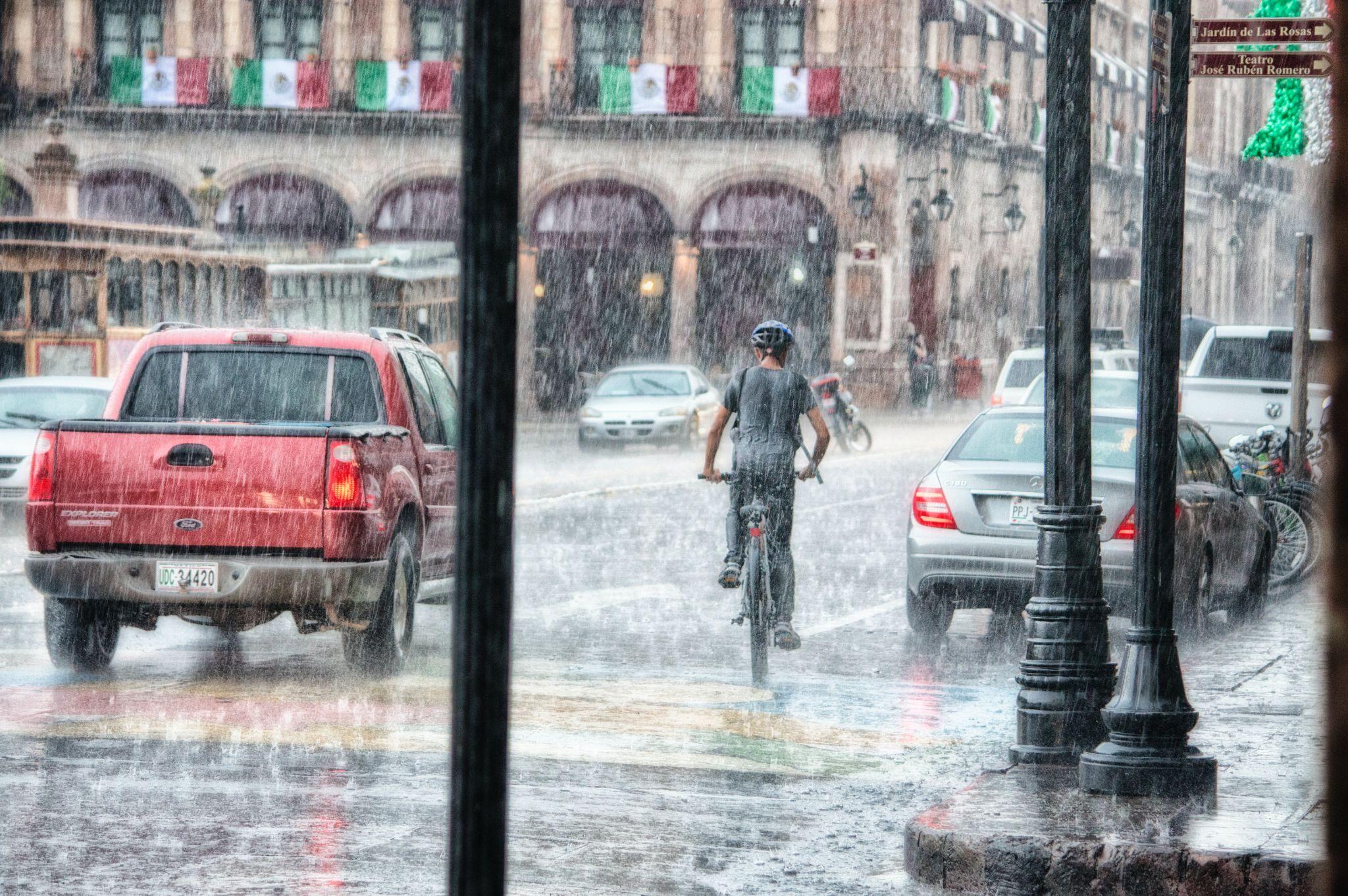 Man riding bicycle in the rain