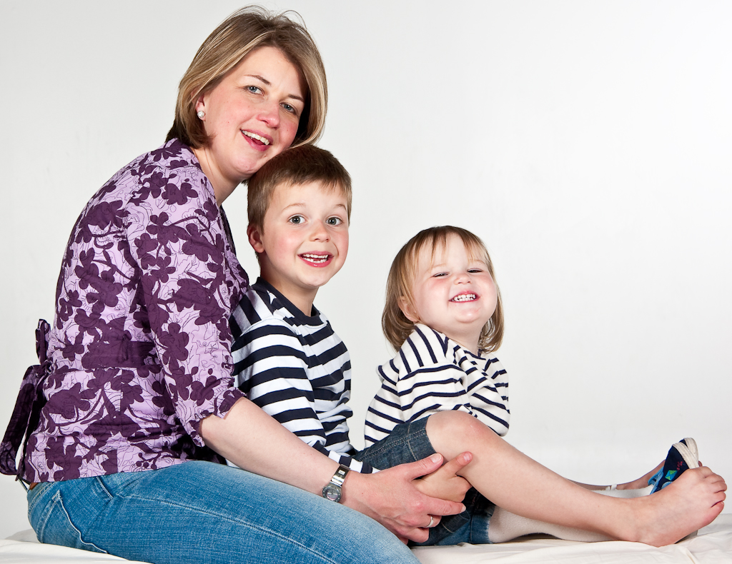 Mother and two children posing for a portrait.