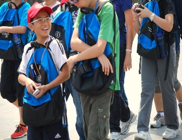Child wearing a backpack in front of him