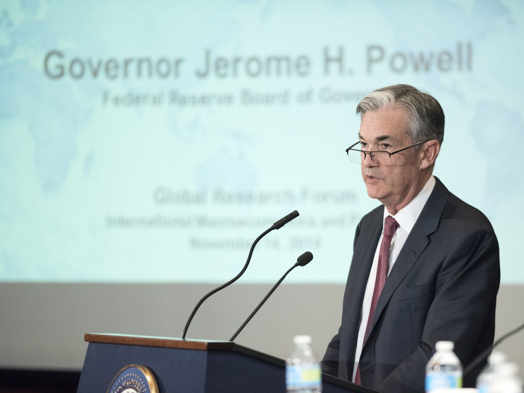 A photograph shows Fed Chairperson Jay Powell speaking at a podium.