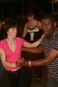 Color photograph of a couple casually dancing.