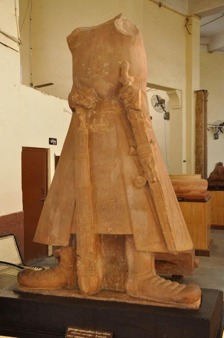 Stone Statue of King Kanishka with a frontality and martial stance, as he holds firmly his sword and a mace.