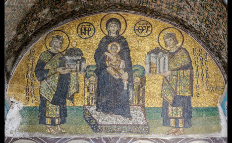 This artwork shows four people. Each has a halo around their head. On the left, Emperor Justinian holds a miniature building. On the right, Emperor Constantine holds another miniature building. In the center, Mary holds the child Jesus in her lap.