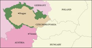 This drawing is a colored map showing the city of Prague in the top left, located in the country of Czechoslovakia. Austria is to the south, with Vienna labeled in the northeast of the country. To the right of Austria, in the lower part of the map is the country of Hungary. Poland is to the north of Czechoslovakia, and Germany is to the northwest. The northwestern half of Czechoslovakia is shaded dark yellow and bordered by a dark green shading. Austria is shaded dark pink. The rest of the left side of the map is shaded light pink. The right side of the map is shaded light yellow.