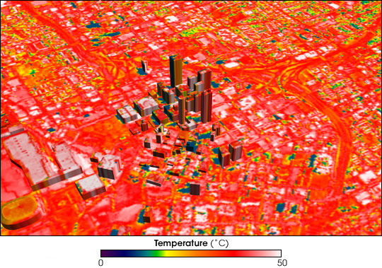 Aerial view centered on downtown Atlanta, GA with its tall buildings at the center taken with thermal imaging and so the areas surrounding the dark, less hot buildings are brightly colored red to indicate high temperatures.