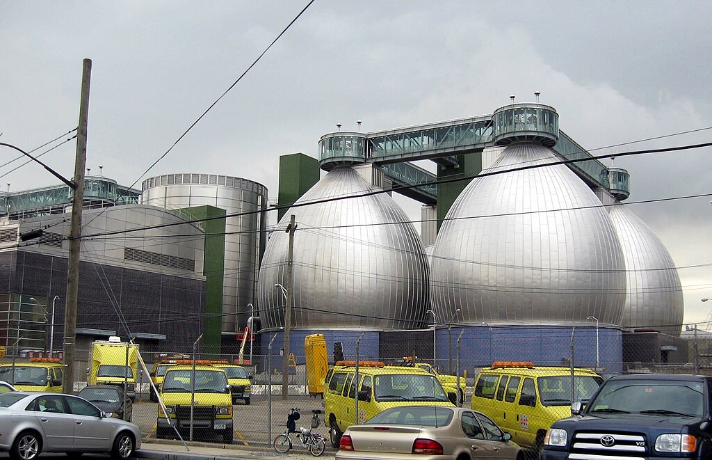 View of onion-shaped digester tanks. There is a cluster of four visible.