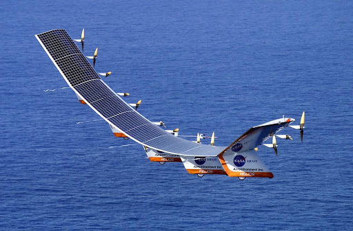 A solar-powered aircraft flying over the sea. Solar cells are on the upper surface of the wings, where they are exposed to sunlight.