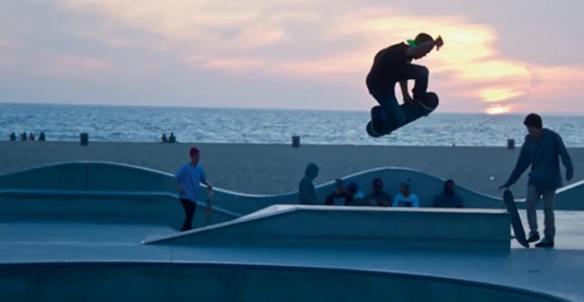 Image of person on skateboard at a skate park