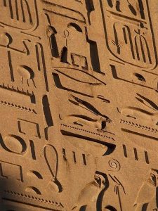 Heiroglyphics carved into a stone wall.