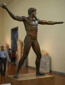 A statue of a nude male figure aiming to throw something (now missing)