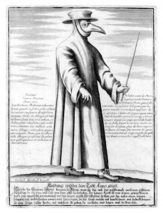 A figure with a crow head. The figure is wearing a hat, holding a wand, and wearing gown with a human like body.
