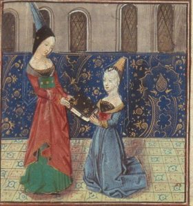 This picture depicts two women in medieval-style clothes. One is standing and gives a book to the woman who is kneeling.
