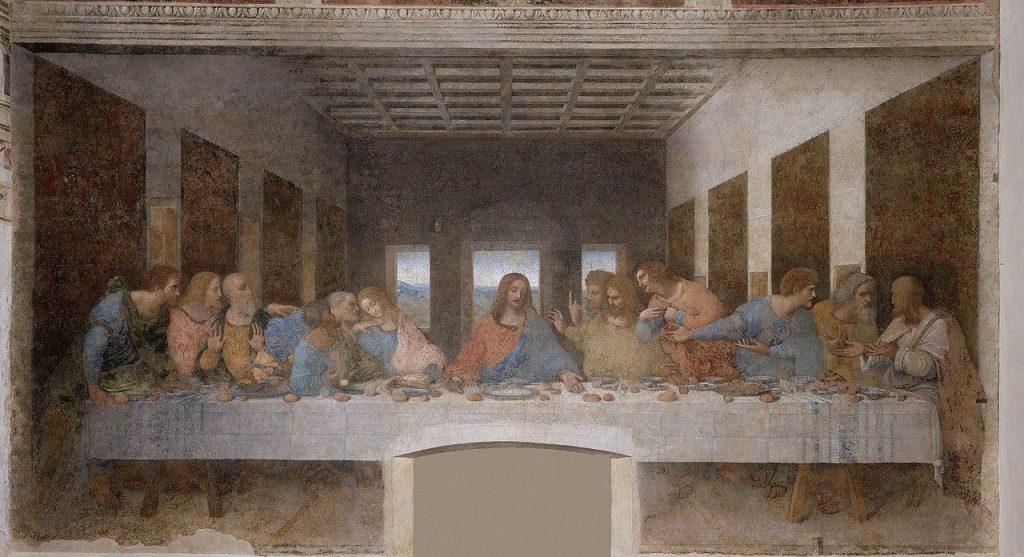 Jesus and the twelve disciples sit at a table. Jesus is in the center and the disciples argue with each other