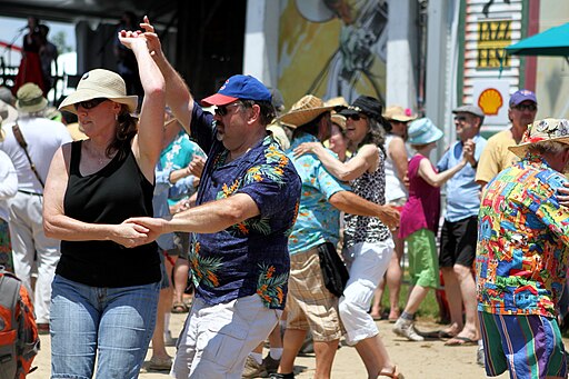 A photo of couples dancing at the Fais Do Do stage at New Orleans Jazz & Heritage Festival.