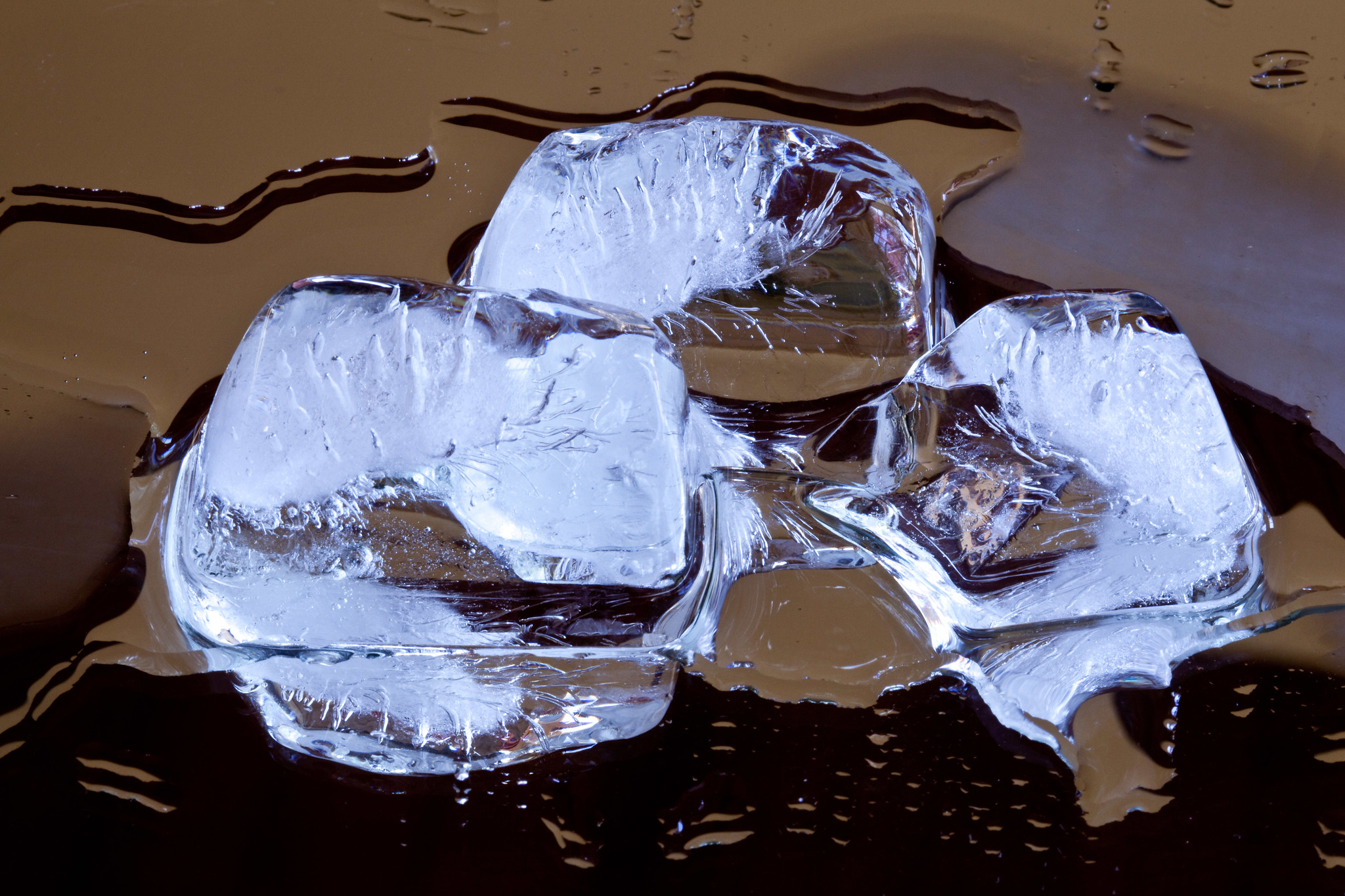 Photo of three melting ice cubes.