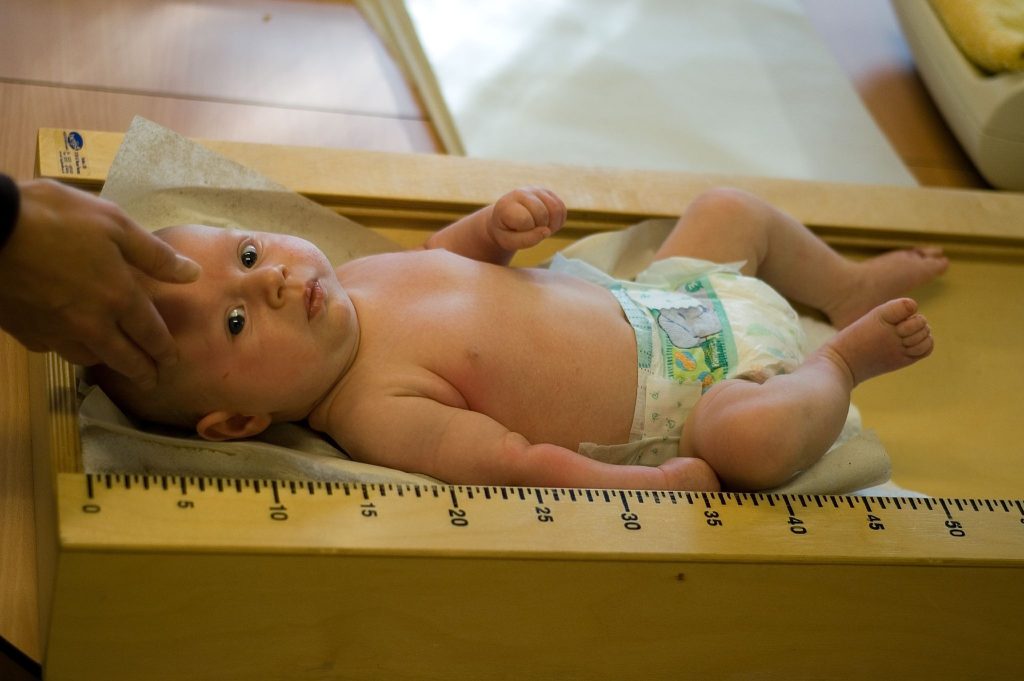 Infant being measured