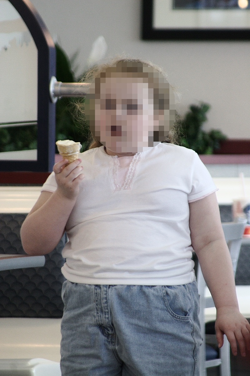 Photo showed an obese school-aged girl eating an ice cream cone.