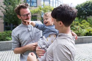 Photo of LGBT people parenting an infant boy.