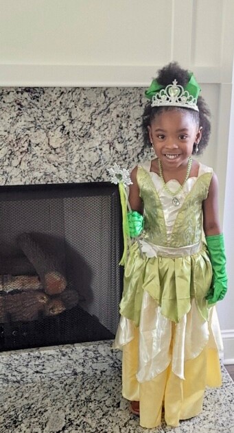 Photo shows a preschool-aged girl wearing a costume from Disney's "Princess and the Frog."