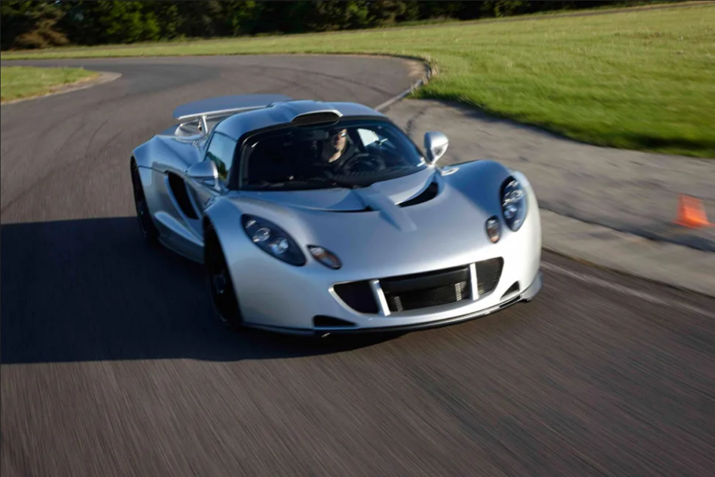 A photo of a Hennessey Venom GT sports car speeding along a winding road.