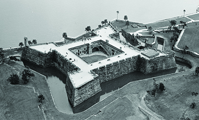 An aerial photograph shows the Spanish fort of Castillo de San Marcos.