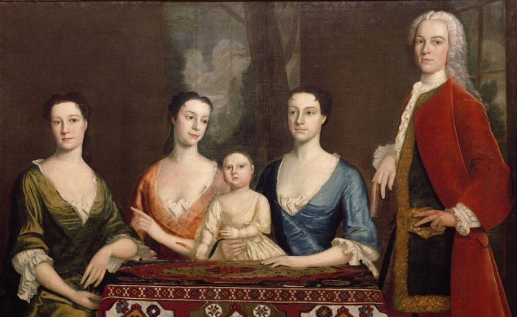 A painting depicts Isaac Royall with three women and a small child. Royall stands; the women are seated at his side. All are dressed formally in the fashion of the times, with the women in low-necked gowns with ruffled sleeves and Royall in a long coat and a white ruffled cravat.