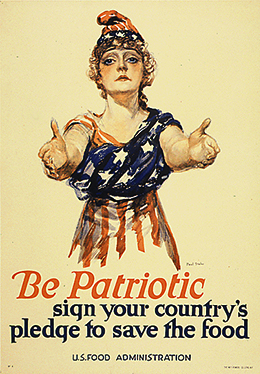 A poster shows a drawing of a young White woman with her arms outstretched toward the viewer. She wears an American flag wrapped around her body and a matching cap. The text reads “Be patriotic. Sign your country’s pledge to save the food. U.S. Food Administration.”