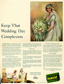 An advertisement headlined “Keep That Wedding Day Complexion” features an illustration of a rosy-cheeked, elaborately dressed bride. An image of Palmolive soap is shown alongside a lengthy description of the soap’s benefits. At the bottom, to illustrate that the soap contains oils used by Cleopatra, an image depicts two rosy-cheeked, White women dressed in flowing garments and seated in a room whose décor is reminiscent of ancient Egypt.