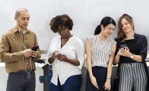 Group of diverse people using smartphones